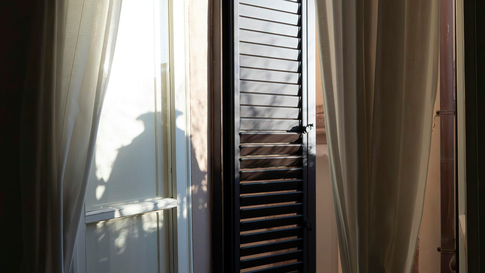 A calendar open to a week, with a sunrise visible through a window